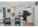 Well-lit kitchen featuring a large island, white cabinetry, and an inviting adjacent dining area at 2423 Auld Scot Blvd, Ocoee, FL 34761