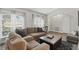 Cozy living room featuring large sectional sofa, stylish curtains, and modern coffee table at 2423 Auld Scot Blvd, Ocoee, FL 34761