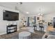Open concept living space with TV, barstool seating, and view to the kitchen at 2423 Auld Scot Blvd, Ocoee, FL 34761