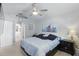 Serene main bedroom with ceiling fan, accent artwork, and ensuite bathroom access at 2423 Auld Scot Blvd, Ocoee, FL 34761