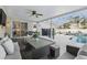 Inviting covered patio with ceiling fan, dining area, and views of the pool and outdoor entertainment space at 2423 Auld Scot Blvd, Ocoee, FL 34761
