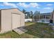 Exterior backyard view featuring a shed with ramp and the screened in pool area at 2423 Auld Scot Blvd, Ocoee, FL 34761