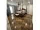 Spacious bedroom featuring a decorative four-post bed, tile floors and natural lighting at 2737 Merrieweather Ln, Kissimmee, FL 34743