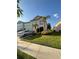 Two-story townhouse with a well-maintained lawn and manicured landscaping at 2737 Merrieweather Ln, Kissimmee, FL 34743