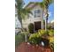 Charming two-story home with well-maintained landscaping and mature palm trees at 2737 Merrieweather Ln, Kissimmee, FL 34743