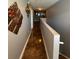 Upstairs hallway featuring decorative artwork, marble-look tile flooring, and neutral paint at 2737 Merrieweather Ln, Kissimmee, FL 34743