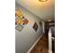 Upstairs hallway featuring decorative artwork, marble-look tile flooring, and neutral paint at 2737 Merrieweather Ln, Kissimmee, FL 34743