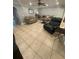 Bright living room featuring tile floors, comfortable seating, and an archway to the hallway at 2737 Merrieweather Ln, Kissimmee, FL 34743