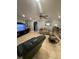 Bright living room featuring tile floors, comfortable seating, and an archway to the hallway at 2737 Merrieweather Ln, Kissimmee, FL 34743