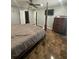 Spacious main bedroom with en suite bathroom, four-poster bed, and dark brown marble-look flooring at 2737 Merrieweather Ln, Kissimmee, FL 34743