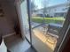 Enjoy outdoor living on this patio with a table and chairs set, overlooking a lovely green lawn at 2737 Merrieweather Ln, Kissimmee, FL 34743