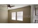 Neutral bedroom featuring a ceiling fan, large windows, and neutral walls at 2834 Bella Vista Dr, Haines City, FL 33844