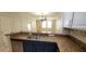 Open kitchen with stainless steel appliances, granite countertops, and ample cabinet storage at 2834 Bella Vista Dr, Haines City, FL 33844