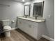Renovated bathroom featuring double sinks with stone countertop, ample storage and updated fixtures at 2975 Avenue G Nw, Winter Haven, FL 33880