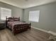 Comfortable bedroom featuring wood-look flooring and a brightly lit window at 2975 Avenue G Nw, Winter Haven, FL 33880