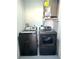 A laundry room with modern washer and dryer appliances at 2975 Avenue G Nw, Winter Haven, FL 33880