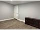 Living area with modern wood-look flooring and dark entertainment center at 2975 Avenue G Nw, Winter Haven, FL 33880