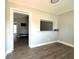 An empty living room with new flooring and light gray paint at 2975 Avenue G Nw, Winter Haven, FL 33880