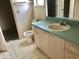 Bathroom with a toilet, a single sink vanity, and tile flooring at 307 Santa Clara Cir, Lady Lake, FL 32159