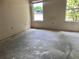 Bedroom featuring two windows and an empty floor at 307 Santa Clara Cir, Lady Lake, FL 32159
