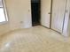 A bright bedroom with a window, closet, and doorway to an additional room at 307 Santa Clara Cir, Lady Lake, FL 32159