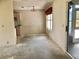 Bright dining room with adjacent kitchen area, featuring a large window and chandelier at 307 Santa Clara Cir, Lady Lake, FL 32159