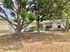 A home's facade is partially concealed by lush trees, offering a glimpse of a well-maintained yard at 307 Santa Clara Cir, Lady Lake, FL 32159