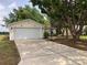 Charming single-story home featuring a spacious driveway and attached two-car garage at 307 Santa Clara Cir, Lady Lake, FL 32159