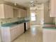 Charming kitchen with light wood cabinets, a double sink, and a view into dining area at 307 Santa Clara Cir, Lady Lake, FL 32159