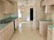 Well-lit kitchen area with light wood cabinets and laminate countertops, and tile flooring at 307 Santa Clara Cir, Lady Lake, FL 32159