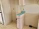 Small area with storage cabinet and aqua countertops at 307 Santa Clara Cir, Lady Lake, FL 32159