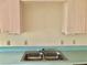 Kitchen sink with aqua counter tops and cabinetry at 307 Santa Clara Cir, Lady Lake, FL 32159