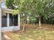 View of screened porch area with trees and black fence line in the background at 307 Santa Clara Cir, Lady Lake, FL 32159