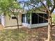 Back screened porch area with green grass and trees at 307 Santa Clara Cir, Lady Lake, FL 32159