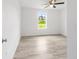 Bright bedroom featuring a ceiling fan and light gray wood-look floors at 315 Fisher Rd, Ocklawaha, FL 32179