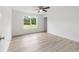 An empty bedroom with laminate floors, neutral colors, and a ceiling fan at 315 Fisher Rd, Ocklawaha, FL 32179
