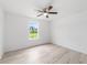 Bright bedroom featuring a ceiling fan and light gray wood-look floors at 315 Fisher Rd, Ocklawaha, FL 32179
