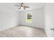 Bright bedroom featuring a ceiling fan and light gray wood-look floors at 315 Fisher Rd, Ocklawaha, FL 32179