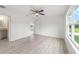 Light filled bedroom featuring sleek floors, fresh paint, and a ceiling fan at 315 Fisher Rd, Ocklawaha, FL 32179