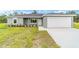 Beautiful single-story home with a two-car garage and landscaped front yard at 315 Fisher Rd, Ocklawaha, FL 32179