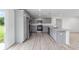 Bright kitchen features stainless steel appliances, gray cabinetry, and granite countertops at 315 Fisher Rd, Ocklawaha, FL 32179