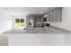 Spacious kitchen with gray cabinetry, granite countertops, stainless steel appliances, and a sliding glass door at 315 Fisher Rd, Ocklawaha, FL 32179