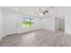 Bright open living area with a view of the landscape through a large window at 315 Fisher Rd, Ocklawaha, FL 32179