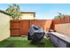 Backyard with artificial grass, wood fence and storage, featuring a covered grill at 3251 Oak Lake Pl # 135, Winter Park, FL 32792