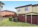Home exterior with backyard featuring privacy fence, shed, and mature landscaping at 3251 Oak Lake Pl # 135, Winter Park, FL 32792