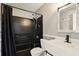 Updated bathroom featuring a shower with black tile and white vanity at 3251 Oak Lake Pl # 135, Winter Park, FL 32792