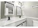 Stylish bathroom featuring double sinks, decorative mirrors, and modern fixtures at 3251 Oak Lake Pl # 135, Winter Park, FL 32792