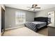 Bedroom with a tufted headboard, ceiling fan and natural light from a large window at 3251 Oak Lake Pl # 135, Winter Park, FL 32792