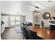 Bright dining space with table for six and a modern light fixture at 3251 Oak Lake Pl # 135, Winter Park, FL 32792