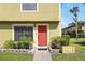 Charming townhome featuring a striking red door and manicured garden at 3251 Oak Lake Pl # 135, Winter Park, FL 32792